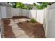 Fenced backyard with a stone paver path and mulch throughout at 9713 W Chatfield Ave # H, Littleton, CO 80128