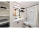Bathroom featuring a shower, a vanity with sink, a mirror, and a storage shelf at 9713 W Chatfield Ave # H, Littleton, CO 80128