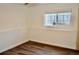 Bright bedroom featuring a window, neutral paint, and attractive laminate floors at 9713 W Chatfield Ave # H, Littleton, CO 80128
