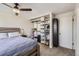 Bedroom featuring a bed, a closet, a ceiling fan, carpeted floors, and natural light at 9713 W Chatfield Ave # H, Littleton, CO 80128