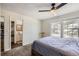 Bedroom featuring a bed, a ceiling fan, carpeted floors, a window, and a bathroom at 9713 W Chatfield Ave # H, Littleton, CO 80128