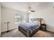 Bedroom featuring a bed, a ceiling fan, carpeted floors, and a window letting in natural light at 9713 W Chatfield Ave # H, Littleton, CO 80128