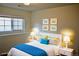 Well-lit bedroom with white furniture, colorful accents, and playful car-themed art at 9713 W Chatfield Ave # H, Littleton, CO 80128