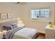 This virtually staged bedroom has a ceiling fan, white trim and neutral decor at 9713 W Chatfield Ave # H, Littleton, CO 80128