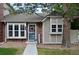 Charming home featuring brick and siding exterior, lovely front yard, and welcoming front door at 9713 W Chatfield Ave # H, Littleton, CO 80128