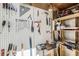 Organized garage features a pegboard and shelving to store tools at 9713 W Chatfield Ave # H, Littleton, CO 80128