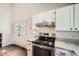 Bright kitchen boasts stainless steel appliances, white cabinets, and access to the exterior via a double door at 9713 W Chatfield Ave # H, Littleton, CO 80128