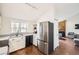 Updated kitchen with stainless steel appliances, white cabinetry, and sleek countertops, open to the living area at 9713 W Chatfield Ave # H, Littleton, CO 80128