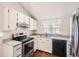 Modern kitchen featuring stainless steel appliances, white cabinets, and updated countertops for a stylish look at 9713 W Chatfield Ave # H, Littleton, CO 80128