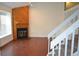Bright living room with a fireplace, hardwood floors, and staircase, creating an open and airy space at 9713 W Chatfield Ave # H, Littleton, CO 80128