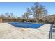 Community pool with lounge chairs, covered with a protective blue tarp at 9713 W Chatfield Ave # H, Littleton, CO 80128