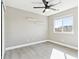 This bedroom features gray walls, a window, floating shelves, a ceiling fan, and wood-look flooring at 2520 E 127Th Ave, Thornton, CO 80241