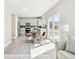 Modern kitchen and dining area with white cabinets and stainless steel appliances at 2520 E 127Th Ave, Thornton, CO 80241