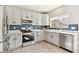 Modern kitchen featuring stainless steel appliances, sleek grey cabinets, and a subway tile backsplash at 2520 E 127Th Ave, Thornton, CO 80241