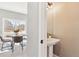 Modern powder room with pedestal sink and view of the dining area at 2520 E 127Th Ave, Thornton, CO 80241