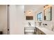Bright bathroom featuring modern vanity and soaking tub with natural light at 2231 Meadow Green Cir, Franktown, CO 80116
