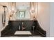 Powder room with marble countertop, decorative mirror, and hanging lights at 2231 Meadow Green Cir, Franktown, CO 80116