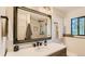 Bathroom featuring single sink vanity, modern mirror, and tiled stand up shower at 2231 Meadow Green Cir, Franktown, CO 80116
