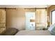 Bedroom features sliding barn doors to bath, decorative chandelier and slider access to porch at 2231 Meadow Green Cir, Franktown, CO 80116