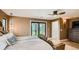 Bedroom with hardwood floors, neutral walls, slider access to covered porch, ceiling fan and dresser at 2231 Meadow Green Cir, Franktown, CO 80116