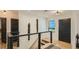 Entryway with modern design and stylish staircase, featuring hardwood floors and a black door at 2231 Meadow Green Cir, Franktown, CO 80116