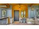 An inviting front porch with stone accents, lanterns, and wood paneling at 2231 Meadow Green Cir, Franktown, CO 80116