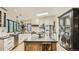Bright kitchen features a large island with seating, modern appliances, and black trimmed windows at 2231 Meadow Green Cir, Franktown, CO 80116