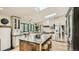 Bright kitchen features an island, stainless steel appliances, skylights, and black trimmed windows at 2231 Meadow Green Cir, Franktown, CO 80116