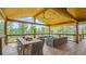 Expansive porch features an outdoor dining and lounge area, perfect for entertaining with scenic views at 2231 Meadow Green Cir, Franktown, CO 80116