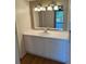 Well-lit bathroom featuring a large vanity with sink, ample counter space, and updated lighting at 8060 E Girard Ave # 504, Denver, CO 80231