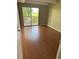 Cozy bedroom with wood-look flooring and sliding glass doors leading to private balcony at 8060 E Girard Ave # 504, Denver, CO 80231