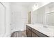 Well-lit bathroom featuring double sinks, wood cabinets, and a shower at 13412 E 110Th Way, Commerce City, CO 80022
