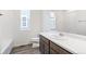 Clean bathroom featuring a single sink, wood cabinets, and a tub with shower at 13412 E 110Th Way, Commerce City, CO 80022