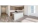 Open kitchen with stainless appliances, island, and quartz countertops at 13412 E 110Th Way, Commerce City, CO 80022