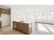Bright kitchen features a center island, stainless steel dishwasher, and modern countertops at 13412 E 110Th Way, Commerce City, CO 80022