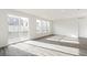Bright living room features sliding glass door and wood-look flooring at 13412 E 110Th Way, Commerce City, CO 80022