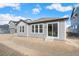 New construction home featuring gray horizontal siding, white trim, and sliding glass door at 13412 E 110Th Way, Commerce City, CO 80022