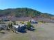 Scenic aerial view of a luxurious home nestled amongst rolling hills and lush greenery at 4749 Starfire Cir, Castle Rock, CO 80104