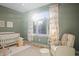 Bright Bedroom with large arched window, soft carpeting, a comfortable chair, and adorable animal-themed decor at 4749 Starfire Cir, Castle Rock, CO 80104