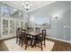 Elegant dining room featuring hardwood floors, a large window, and modern chandelier at 4749 Starfire Cir, Castle Rock, CO 80104