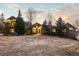 Inviting exterior view of home with mature trees, lush lawn and warm lighting at 4749 Starfire Cir, Castle Rock, CO 80104
