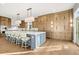 Bright kitchen features a large island with seating, ample cabinetry, quartz countertops, and hardwood flooring at 4749 Starfire Cir, Castle Rock, CO 80104
