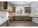 Well-appointed kitchen with ample cabinetry, stainless steel appliances, and tiled backsplash at 4749 Starfire Cir, Castle Rock, CO 80104