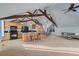 Open living space with vaulted ceilings, exposed wood beams, island kitchen and dining area at 4749 Starfire Cir, Castle Rock, CO 80104
