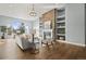 Inviting living room featuring a stone fireplace, built-in shelving, and hardwood floors at 4749 Starfire Cir, Castle Rock, CO 80104