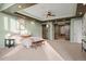 Bright main bedroom featuring a tray ceiling, large windows, barn door access, and a king-sized bed at 4749 Starfire Cir, Castle Rock, CO 80104