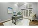 Bright home office with large windows, modern desk, and comfortable seating area at 4749 Starfire Cir, Castle Rock, CO 80104