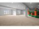 Large recreation room with plush carpeting, bright windows, and a fun bounce house for hours of entertainment at 4749 Starfire Cir, Castle Rock, CO 80104
