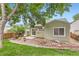The property shows a backyard with mature trees, a rock garden and a concrete patio at 9705 Autumnwood Pl, Highlands Ranch, CO 80129