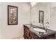 Bathroom featuring double vanity, a large mirror, and decorative accents at 9705 Autumnwood Pl, Highlands Ranch, CO 80129